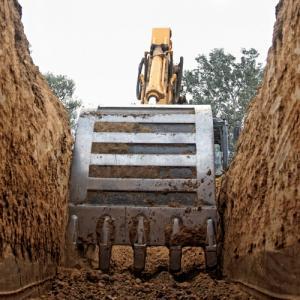 Excavator digging a deep trench